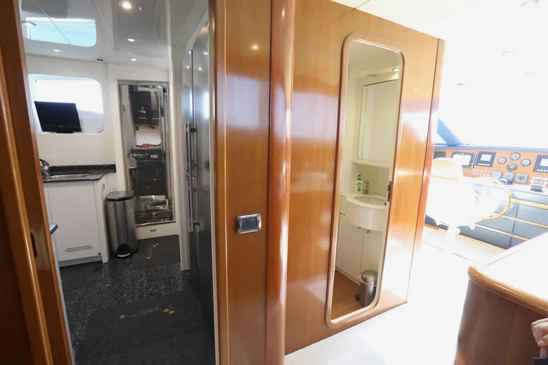  Yacht Photos Pics Interior of a 2005 Falcon 90 yacht, featuring a modern bathroom and control area.