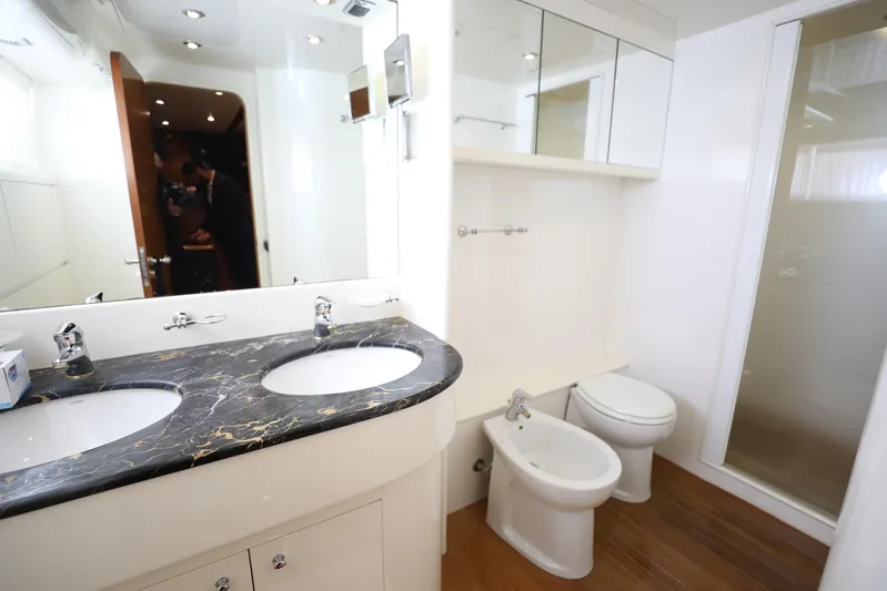  Yacht Photos Pics Luxurious bathroom in 2005 Falcon 90 yacht with dual sinks and modern fixtures.