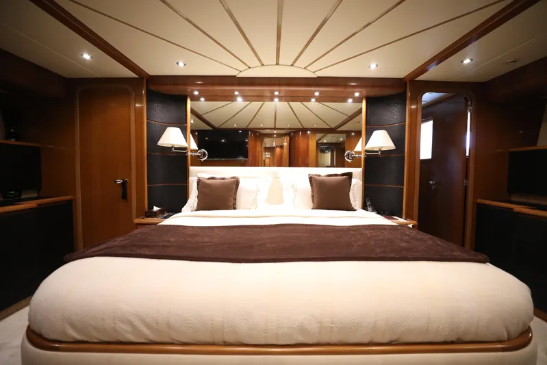  Yacht Photos Pics Luxurious bedroom interior on a 2005 Falcon 90 yacht, featuring elegant lighting and decor.