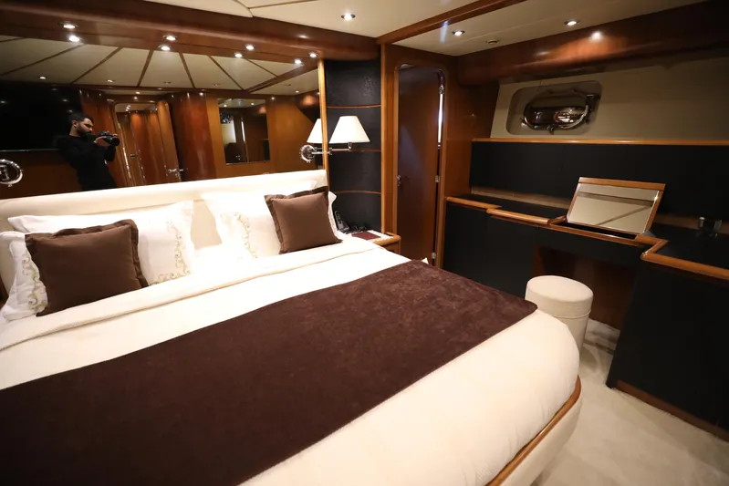  Yacht Photos Pics Luxurious bedroom interior of 2005 Falcon 90 yacht with elegant decor and cozy bedding.