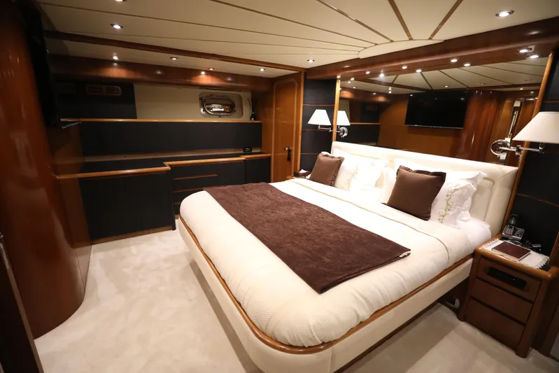  Yacht Photos Pics Luxurious bedroom interior of a 2005 Falcon 90 yacht with elegant furnishings.