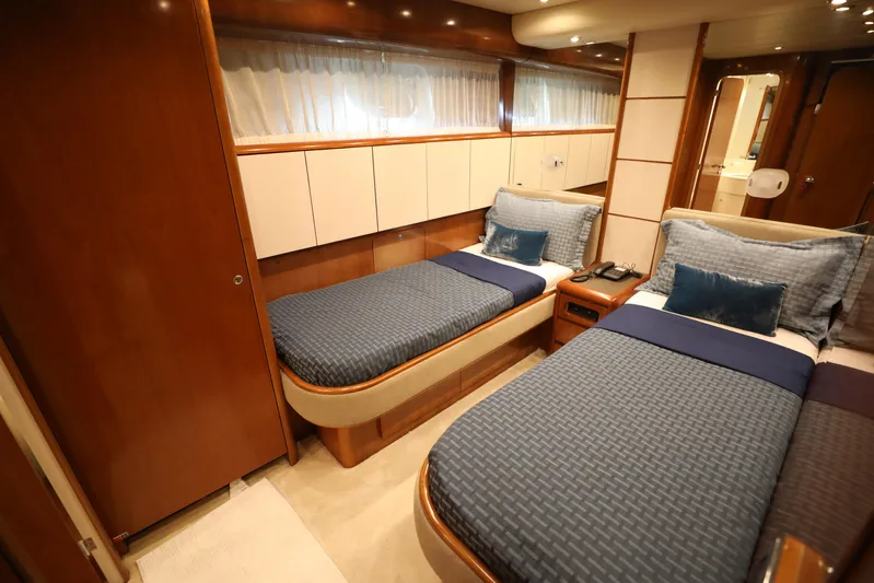  Yacht Photos Pics Luxurious twin bedroom in a 2005 Falcon 90 yacht, featuring elegant wood finishes.