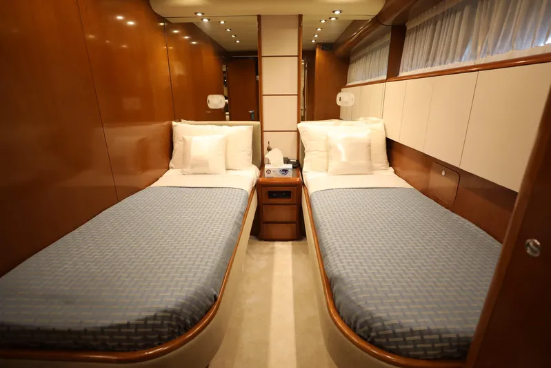  Yacht Photos Pics Luxurious twin cabin interior on 2005 Falcon 90 yacht, featuring elegant wood paneling and cozy bedding.