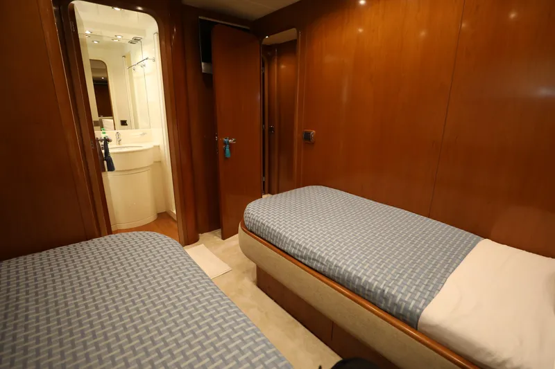  Yacht Photos Pics Twin cabin with wooden paneling in a 2005 Falcon 90 yacht.