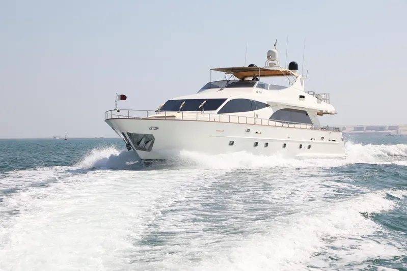  Yacht Photos Pics Luxury Falcon 90 yacht cruising on open water, 2005 model, creating a wake behind.