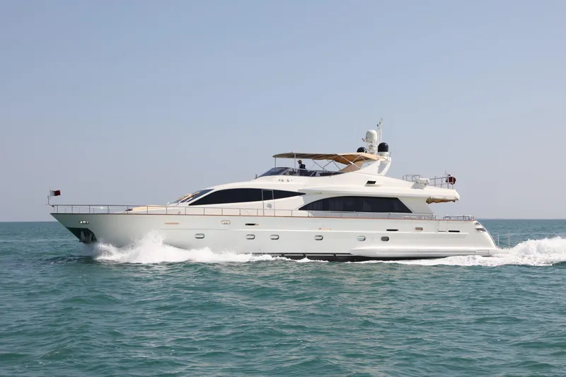  Yacht Photos Pics Luxurious 2005 Falcon 90 yacht cruising on open sea under clear sky.