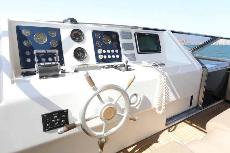  Yacht Photos Pics Cockpit of 2005 Falcon 90 yacht with steering wheel and navigation instruments.