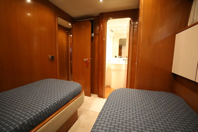 Yacht Photos Pics Twin cabin interior of 2005 Falcon 90 yacht with wooden finish and ensuite bathroom.