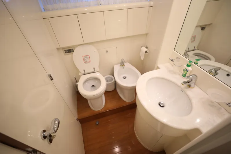  Yacht Photos Pics Compact bathroom in a 2005 Falcon 90 yacht with toilet, bidet, and sink.