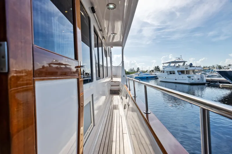 El Legado Yacht Photos Pics 2005 Grand Banks 72 Aleutian RP yacht docked, showcasing sleek wooden deck and marina view.