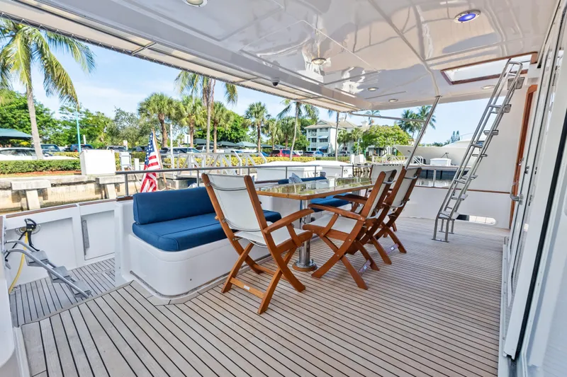 El Legado Yacht Photos Pics Luxury deck of 2005 Grand Banks 72 Aleutian RP yacht with seating and ladder.