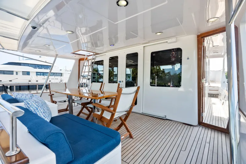 El Legado Yacht Photos Pics Luxurious 2005 Grand Banks 72 Aleutian RP yacht deck with seating and dining area.