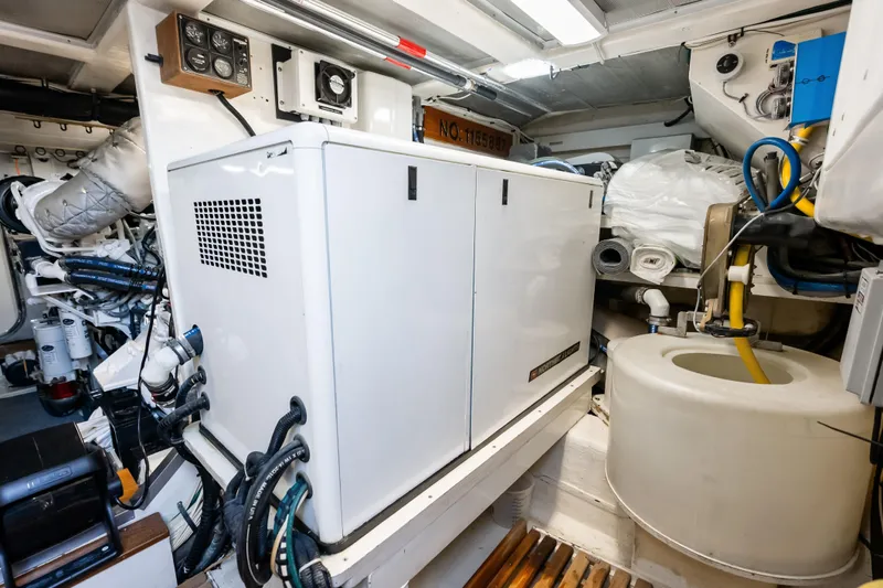 El Legado Yacht Photos Pics Engine room of 2005 Grand Banks 72 Aleutian RP yacht, featuring generator and equipment.