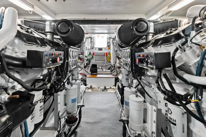 El Legado Yacht Photos Pics Engine room of 2005 Grand Banks 72 Aleutian RP yacht, showcasing dual engines and control systems.