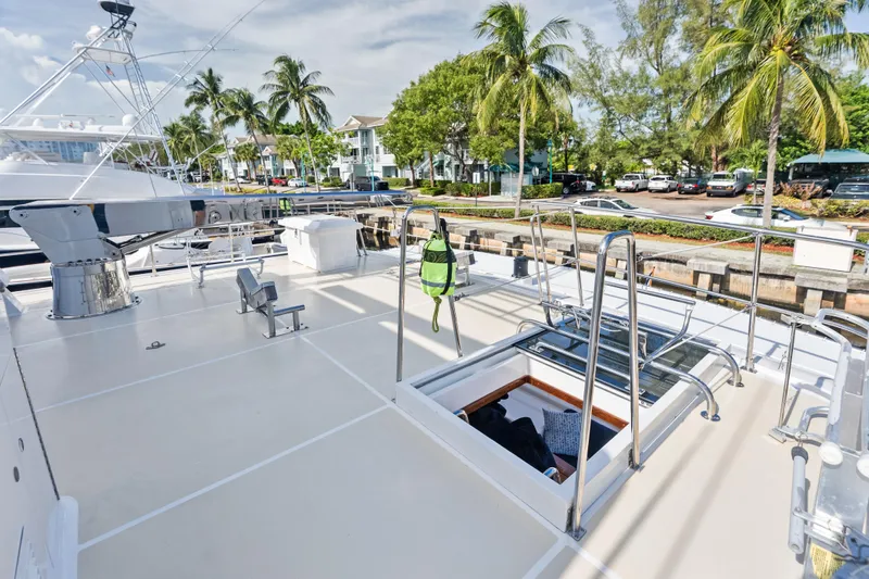 El Legado Yacht Photos Pics 2005 Grand Banks 72 Aleutian RP yacht deck with palm trees and marina view.