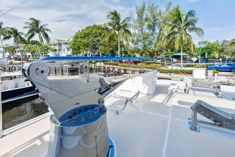 El Legado Yacht Photos Pics 2005 Grand Banks 72 Aleutian RP yacht deck with palm trees and marina view.