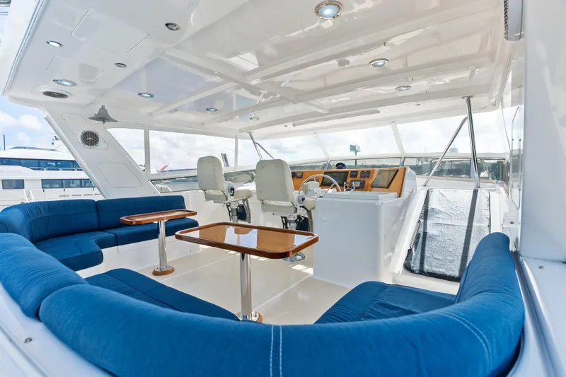 El Legado Yacht Photos Pics Luxurious 2005 Grand Banks 72 Aleutian RP yacht interior with blue seating and helm station.