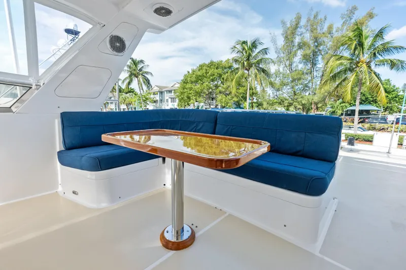 El Legado Yacht Photos Pics Luxurious 2005 Grand Banks 72 Aleutian RP yacht with blue seating and wooden table.