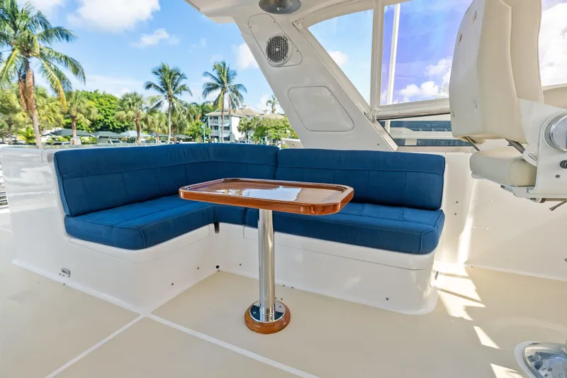 El Legado Yacht Photos Pics Luxurious seating area on 2005 Grand Banks 72 Aleutian RP yacht with blue cushions.