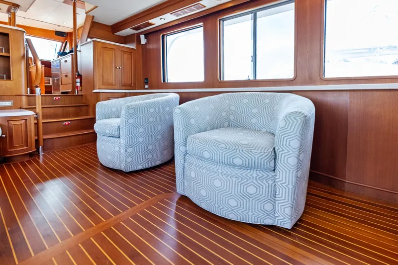 El Legado Yacht Photos Pics Luxurious interior of 2005 Grand Banks 72 Aleutian RP yacht with elegant seating and wood finish.