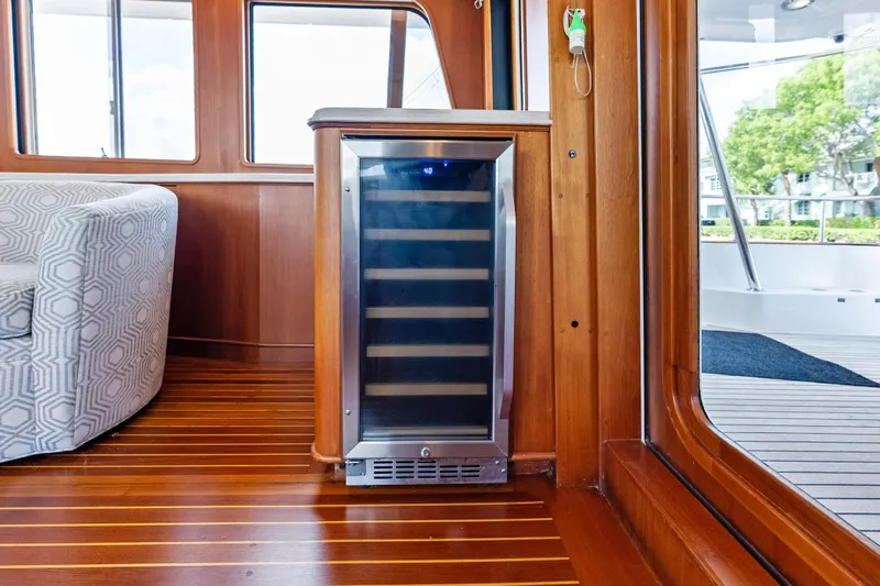 El Legado Yacht Photos Pics Luxurious interior of 2005 Grand Banks 72 Aleutian RP yacht with wine cooler.