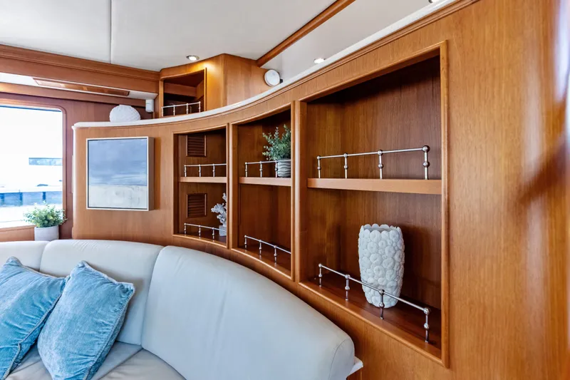El Legado Yacht Photos Pics Luxurious interior of 2005 Grand Banks 72 Aleutian RP yacht with elegant wood shelving.