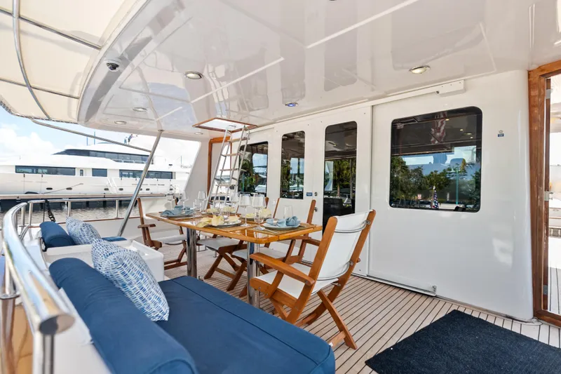 El Legado Yacht Photos Pics Luxurious 2005 Grand Banks 72 Aleutian RP yacht deck with elegant dining setup.