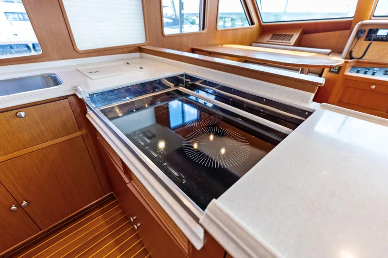 El Legado Yacht Photos Pics Luxurious kitchen area in a 2005 Grand Banks 72 Aleutian RP yacht with modern appliances.