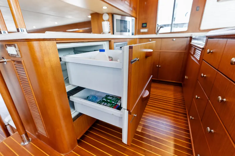 El Legado Yacht Photos Pics Luxury yacht kitchen with open refrigerator drawers, Grand Banks 72 Aleutian RP, 2005 model.