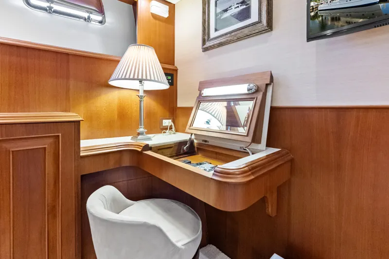 El Legado Yacht Photos Pics Elegant vanity area on 2005 Grand Banks 72 Aleutian RP yacht with lamp and mirror.