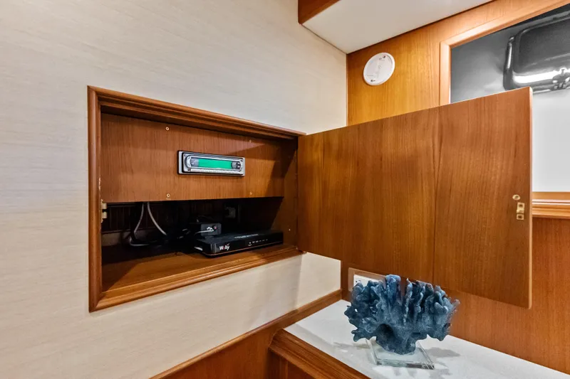 El Legado Yacht Photos Pics Wooden cabinet with electronic equipment inside, aboard 2005 Grand Banks 72 Aleutian RP yacht.