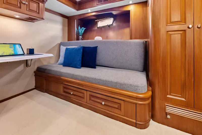 El Legado Yacht Photos Pics Luxurious interior of 2005 Grand Banks 72 Aleutian RP yacht with cozy seating and elegant wood finish.