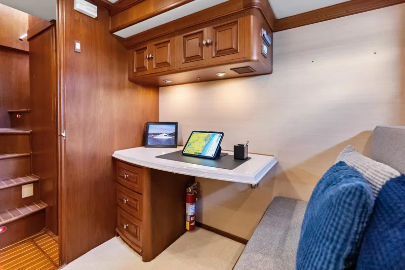 El Legado Yacht Photos Pics Luxurious 2005 Grand Banks 72 Aleutian RP yacht interior with wooden cabinetry and navigation setup.