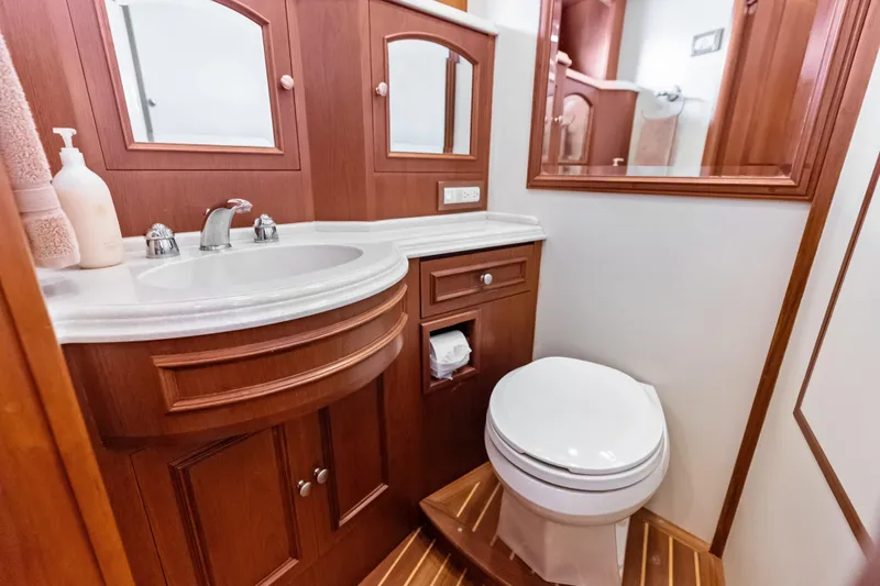 El Legado Yacht Photos Pics Luxurious 2005 Grand Banks 72 Aleutian RP yacht bathroom with wooden cabinetry and modern fixtures.