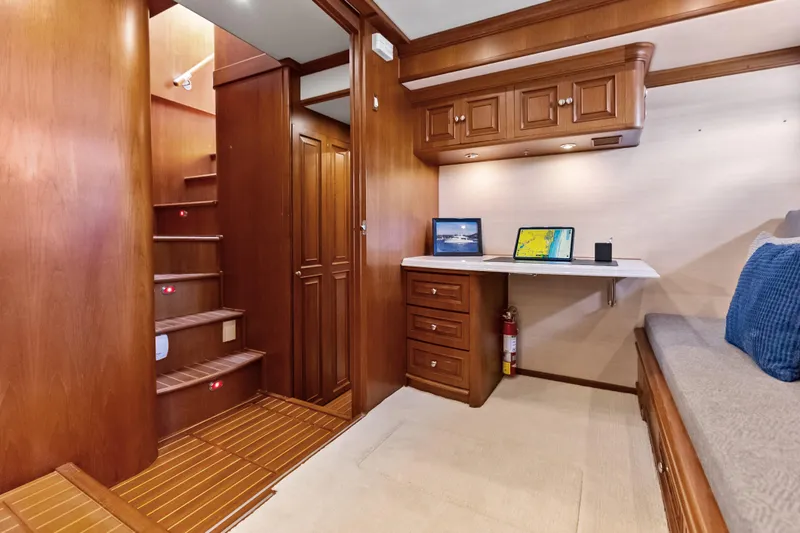 El Legado Yacht Photos Pics Luxurious interior of 2005 Grand Banks 72 Aleutian RP yacht with wooden cabinetry and workspace.