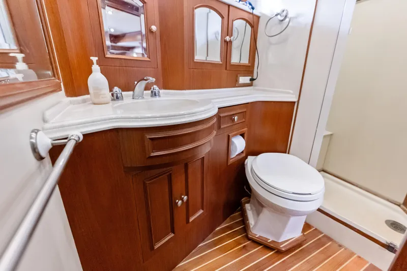 El Legado Yacht Photos Pics Luxurious 2005 Grand Banks 72 Aleutian RP yacht bathroom with wood accents and modern fixtures.