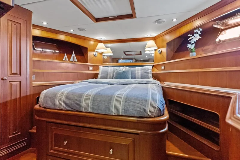 El Legado Yacht Photos Pics Luxurious 2005 Grand Banks 72 Aleutian RP yacht bedroom with elegant wood finish.