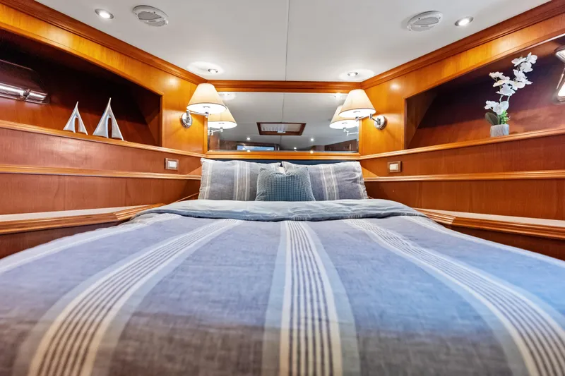El Legado Yacht Photos Pics Luxurious cabin interior of 2005 Grand Banks 72 Aleutian RP yacht with cozy bedding.