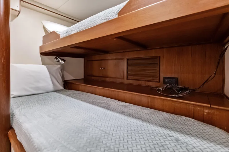El Legado Yacht Photos Pics Bunk beds in 2005 Grand Banks 72 Aleutian RP yacht cabin, featuring wooden interior.