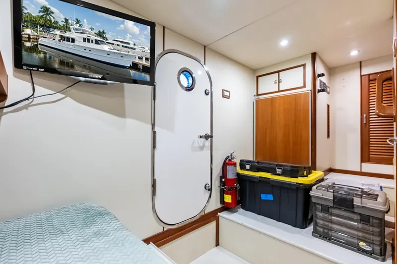 El Legado Yacht Photos Pics Interior of 2005 Grand Banks 72 Aleutian RP yacht with storage boxes and TV.