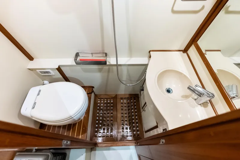 El Legado Yacht Photos Pics Luxurious bathroom in 2005 Grand Banks 72 Aleutian RP yacht, featuring modern fixtures and wooden accents.