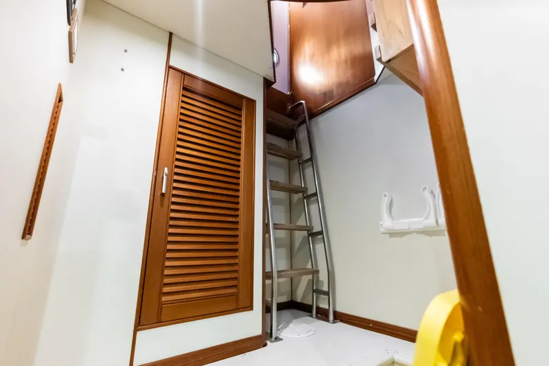 El Legado Yacht Photos Pics Interior of 2005 Grand Banks 72 Aleutian RP yacht with wooden ladder and storage.