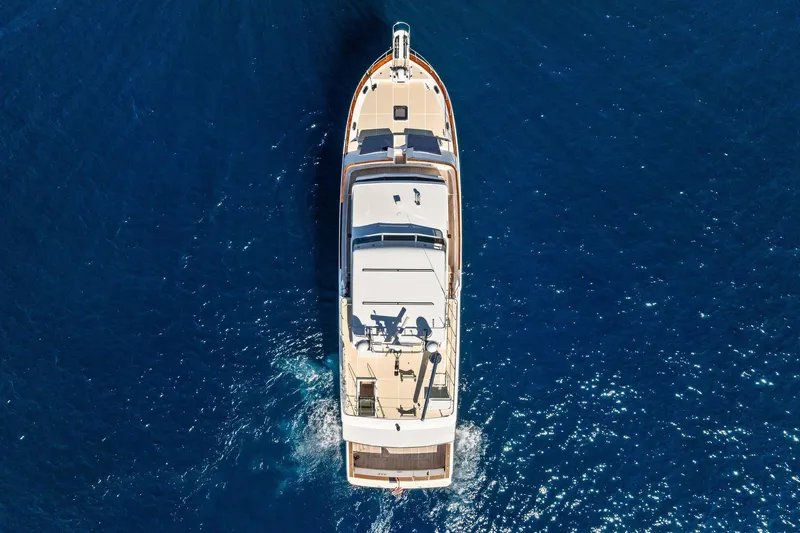 El Legado Yacht Photos Pics Aerial view of 2005 Grand Banks 72 Aleutian RP yacht cruising in blue ocean.