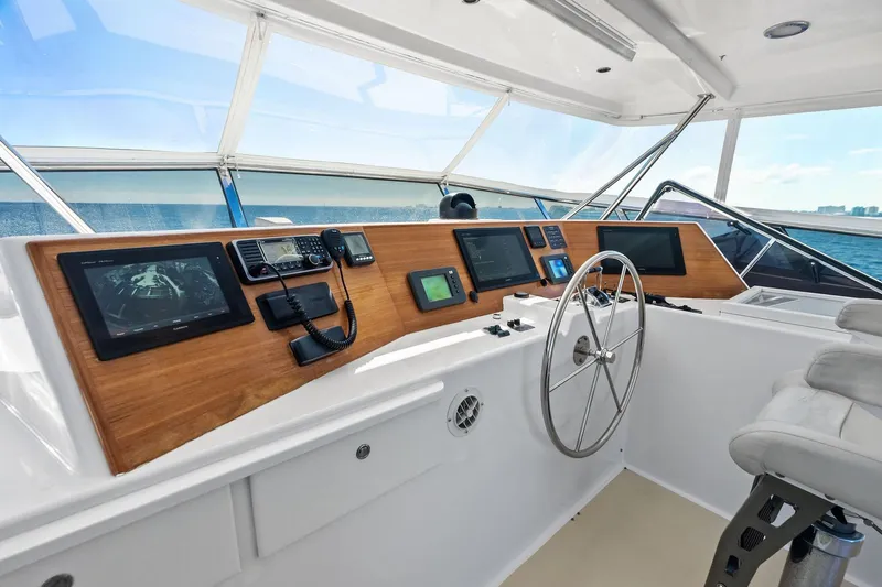 El Legado Yacht Photos Pics Helm of 2005 Grand Banks 72 Aleutian RP yacht with navigation equipment and steering wheel.