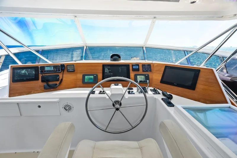 El Legado Yacht Photos Pics Helm of 2005 Grand Banks 72 Aleutian RP yacht with navigation equipment and ocean view.