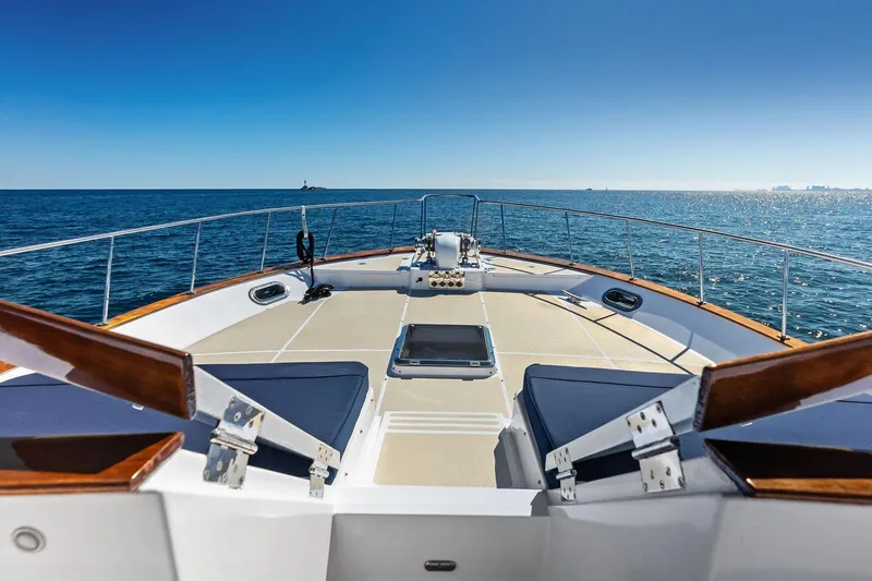 El Legado Yacht Photos Pics 2005 Grand Banks 72 Aleutian RP yacht deck with ocean view and clear blue sky.