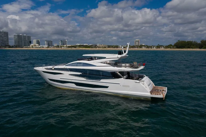  Yacht Photos Pics Luxury Pearl 95 yacht cruising near a city skyline, 2020 model.