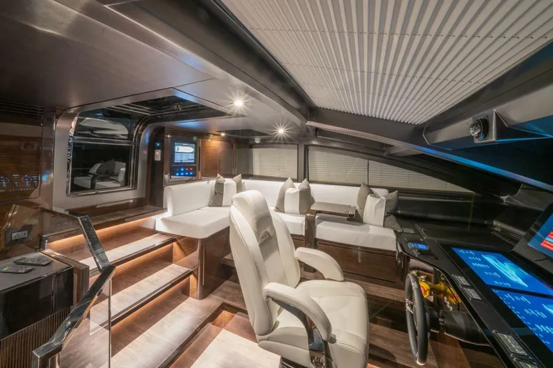  Yacht Photos Pics Luxurious interior of 2020 Pearl 95 yacht with modern seating and advanced control panels.