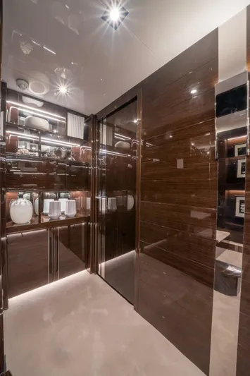  Yacht Photos Pics Luxurious yacht interior with glossy wood paneling and elegant decor, Pearl 95, 2020 model.