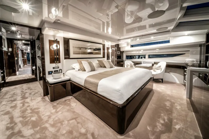  Yacht Photos Pics Luxurious bedroom interior on 2020 Pearl 95 yacht, featuring elegant decor and modern furnishings.